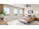 Serene bedroom with three large windows, a ceiling fan, and a comfortable bed at 309 Old Town Village Rd, Waxhaw, NC 28173