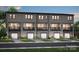 Townhome exterior showing private balconies, covered garages, light gray siding, and meticulous landscaping at 309 Old Town Village Rd, Waxhaw, NC 28173