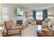 Cozy living room featuring a fireplace, comfortable seating, and large windows at 3810 Rhodes Ave, Charlotte, NC 28210