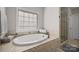 Relaxing bathroom featuring a large soaking tub and walk-in shower at 3976 Stadler Ne Dr, Conover, NC 28613