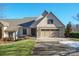 Craftsman style home with light beige siding, two-car garage, and landscaping at 3976 Stadler Ne Dr, Conover, NC 28613