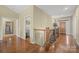Hardwood floor hallway with laundry closet and staircase at 3976 Stadler Ne Dr, Conover, NC 28613