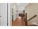 Bright hallway with hardwood floors, leading to a bathroom and living area at 3976 Stadler Ne Dr, Conover, NC 28613