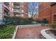 Brick courtyard with green iron fencing and landscaping at 401 N Church St # 507, Charlotte, NC 28202