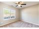 Bright bedroom with double windows, ceiling fan, and carpet flooring at 411 E Old Highway 74 None, Monroe, NC 28112