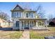 Front view of a charming two-story house needing some TLC at 415 S Race St, Statesville, NC 28677