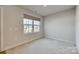 Bright bedroom with a window offering a view of the neighborhood at 525 Grandiflora Ave # 101, Lancaster, SC 29720