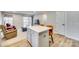 Kitchen island with seating for two and a view into the living room at 525 Grandiflora Ave # 101, Lancaster, SC 29720
