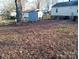 Large backyard with shed and leaf covered ground at 605 Craig St, Monroe, NC 28112