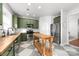 Modern kitchen with green cabinets, butcher block island, and stainless steel appliances at 7426 Coastal Way, Huntersville, NC 28078