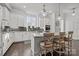 Modern kitchen with white cabinets, granite island, and stainless steel appliances at 7520 Waverly Walk Ave, Charlotte, NC 28277