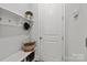 Functional mudroom with built-in bench, shelving, and coat hooks at 7520 Waverly Walk Ave, Charlotte, NC 28277