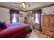 Spacious bedroom with wood furniture and window curtains at 7720 Hal Williams Rd, Kershaw, SC 29067