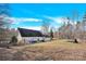 View of the large, fenced backyard with patio, pool, trampoline, and back of the house at 7918 Ridgeview Dr, Sherrills Ford, NC 28673