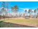 Trampoline and backyard landscape with mature trees and chain-link fence surrounding the perimeter at 7918 Ridgeview Dr, Sherrills Ford, NC 28673