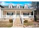 Front view of a two story house with a white porch and stonework at 7918 Ridgeview Dr, Sherrills Ford, NC 28673