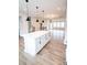 Modern kitchen with a white island, open layout, and stylish lighting fixtures at 7944 Cedarsmith Ct, Charlotte, NC 28217