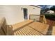 An outdoor back deck made of wooden planks with railing, adjacent to a tan colored house at 819 Wellwood Ave, Statesville, NC 28677