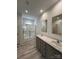 Bright bathroom boasts double sinks, shaker cabinets, and a glass-enclosed shower with tile surround at 819 Wellwood Ave, Statesville, NC 28677