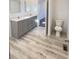 This bathroom features a long double sink vanity, a toilet, and light wood-look flooring at 819 Wellwood Ave, Statesville, NC 28677