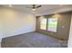 Spacious bedroom with gray accent wall, gray carpet and two windows for natural light at 819 Wellwood Ave, Statesville, NC 28677
