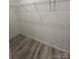 A well-organized closet space featuring a sturdy wire shelf and wood-look flooring at 819 Wellwood Ave, Statesville, NC 28677
