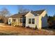 Exterior view of a well-maintained home featuring a side entrance and neatly landscaped front yard at 819 Wellwood Ave, Statesville, NC 28677