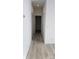 Bright hallway featuring laminate flooring, white walls, and doors along both sides at 819 Wellwood Ave, Statesville, NC 28677