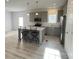 Well-lit kitchen with gray cabinets, stainless steel appliances, and island seating at 819 Wellwood Ave, Statesville, NC 28677
