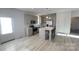 Bright kitchen featuring gray cabinetry, an island with seating, and stainless steel appliances at 819 Wellwood Ave, Statesville, NC 28677