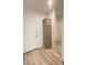 Hallway area with light wood plank flooring, storage cabinet, and a doorway leading to another room at 819 Wellwood Ave, Statesville, NC 28677