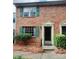 Brick townhouse with green shutters, a front door, and landscaping at 8838 Hunter Ridge Dr, Charlotte, NC 28226