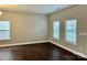 Neutral bedroom featuring hardwood floors and 2 windows for natural light at 9034 Seamill Rd, Charlotte, NC 28278