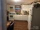 Small kitchen with white cabinets and wood flooring at 935 Brown St, Gastonia, NC 28052