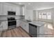Contemporary kitchen boasting white cabinetry, granite counters, and stainless steel appliances at 1104 Verdigris Dr # 803/0803, Gastonia, NC 28054