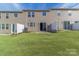 Townhome back patio with a grassy yard and privacy fence at 11234 Bartrams Way, Charlotte, NC 28278