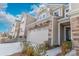 Tan townhome with stone accents and a two-car garage at 11234 Bartrams Way, Charlotte, NC 28278