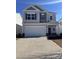 Two-story house with gray siding, white garage door, and landscaping at 1169 Red River Dr, Salisbury, NC 28144