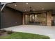 Expansive back patio with sliding glass doors leading to the home's interior and a ceiling fan at 1214 S Kings Dr # A, Charlotte, NC 28207