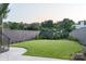 Large, well-manicured backyard with lush lawn, mature trees, and privacy fencing at 1214 S Kings Dr # A, Charlotte, NC 28207