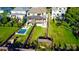 Aerial view of a backyard with a pool, play area, patio, and lush green lawn at 1214 S Kings Dr # A, Charlotte, NC 28207
