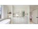 Bright bathroom with double vanity, free standing tub, and open to bedroom at 1214 S Kings Dr # A, Charlotte, NC 28207