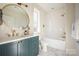 Modern bathroom with a teal vanity and walk-in shower at 1214 S Kings Dr # A, Charlotte, NC 28207