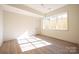 Light-filled bedroom featuring hardwood floors and large window at 1214 S Kings Dr # A, Charlotte, NC 28207