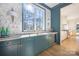 Bright butler's pantry with a large window, custom blue cabinets, and stylish geometric backsplash at 1214 S Kings Dr # A, Charlotte, NC 28207