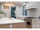 Modern kitchen with stainless steel appliances, quartz countertops, and stylish wicker lighting at 1214 S Kings Dr # A, Charlotte, NC 28207