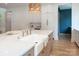 Bright kitchen with farmhouse sink, gold faucet, quartz countertops, and stylish wicker light fixture at 1214 S Kings Dr # A, Charlotte, NC 28207