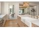 Bright kitchen with a farmhouse sink, gold faucet, stainless steel appliances, and wicker light fixture at 1214 S Kings Dr # A, Charlotte, NC 28207