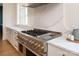 Gourmet kitchen featuring a professional-grade range, custom cabinetry, and quartz countertops with a marble backsplash at 1214 S Kings Dr # A, Charlotte, NC 28207