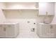 Bright laundry room with hexagon floor tile, built-in cabinets, and a sink at 1214 S Kings Dr # A, Charlotte, NC 28207